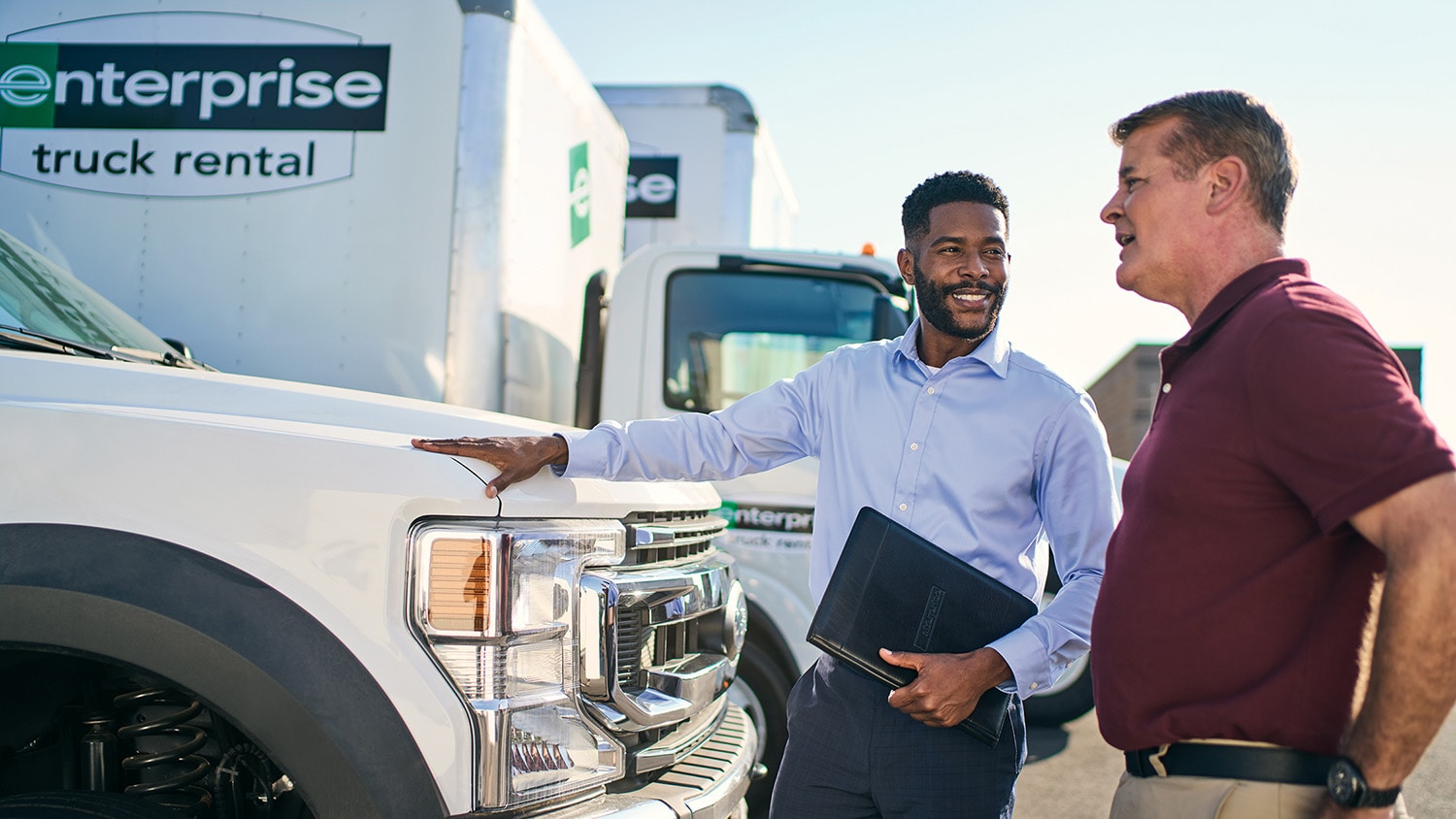 Two people discussing trucks